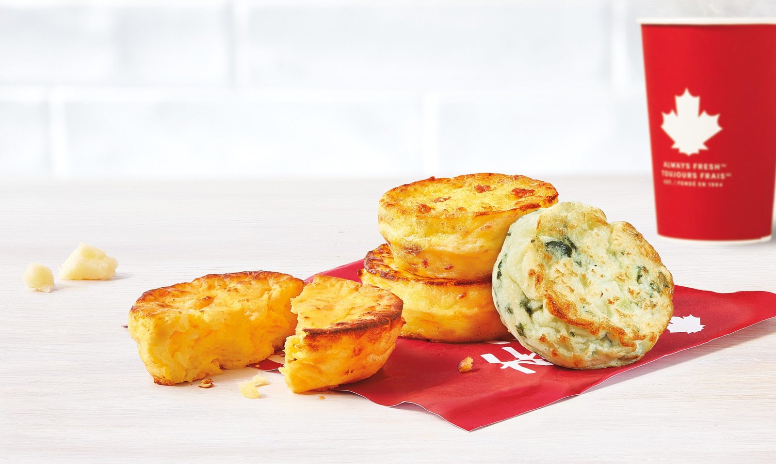Try Tim Hortons' new Four Cheese Omelette Bites! Packed with Gouda, mozzarella, and cheddar, each pair delivers 15g of protein. Also available in Spinach & Egg or Bacon & Cheese!