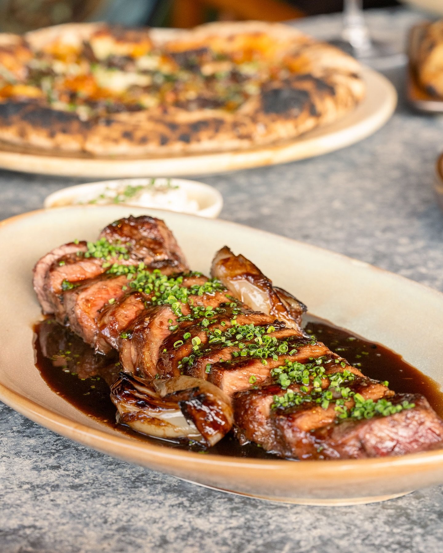Experience Ember, a standout in Ottawa's Byward Market. Enjoy Argentinian charcoal-grilled dishes, wood-fired pizza, creative cocktails, and live music in a stunning setting.