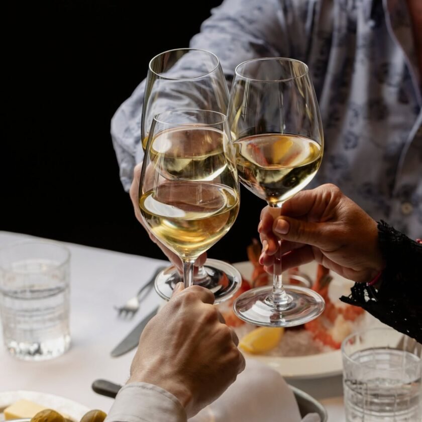 Guests raising wine glasses during dinner at Gibbys in Old Montreal
